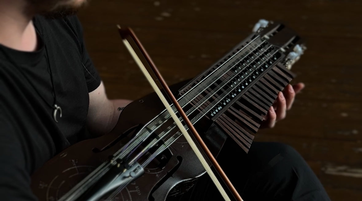 Load video: Video of nyckelharpa demo showing tuning, resonance, and unique  handmade keyed fiddle sound